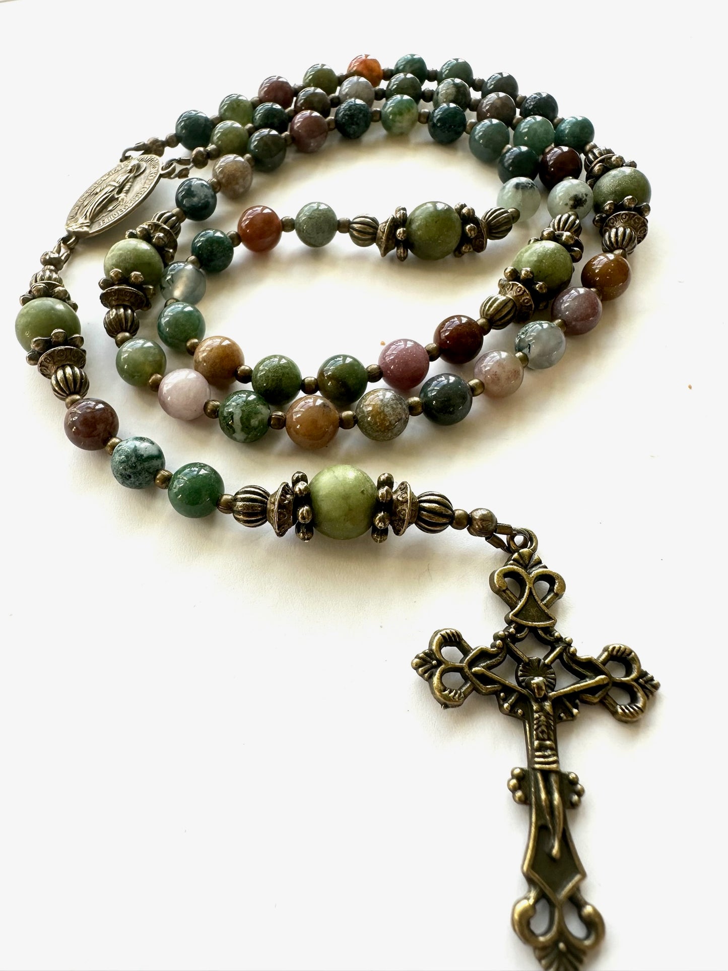Handmade Indian Agate rosary with antique bronze crucifix and Miraculous Medal centerpiece, photographed on white background.