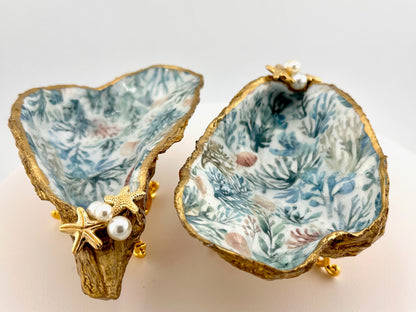 Decorative shell with coral pattern and gold accents on a light background